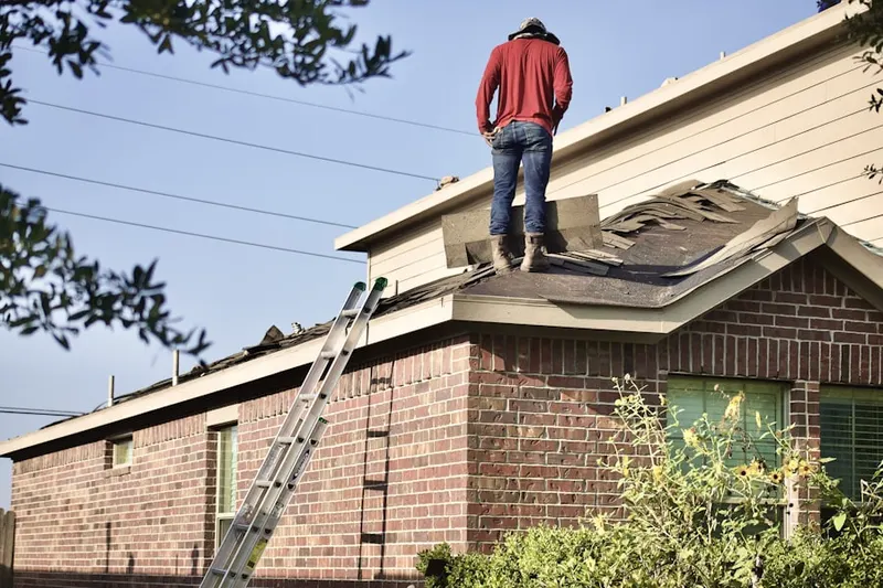 Professional roofer working on a residential roof in Germantown Estates